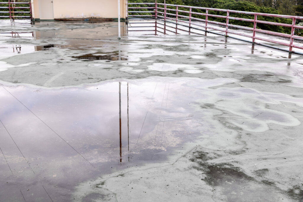 Old flat roof is ponding water and leakage after rain.
