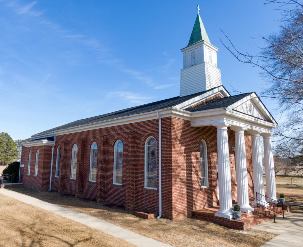  Church with White Columns and Weathered Copper Steeple With Green Patina
