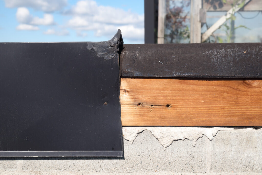 Roof metal flashing removed or blown off.