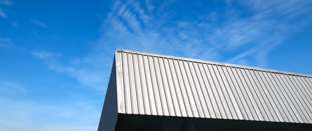 Metal sheet roof curve on blue sky. 