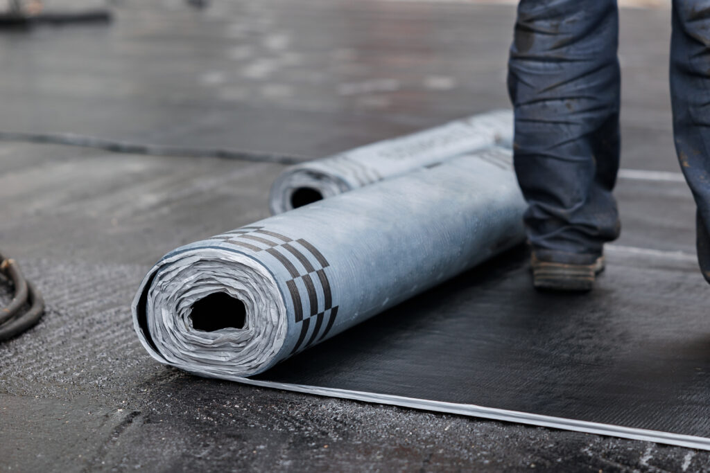Closeup of Rolls of new black roofing felt or bitumen. Selective focus and blurred background